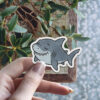 Cute sleepy shark with a happy grin, scratch-resistant satin finish sticker.