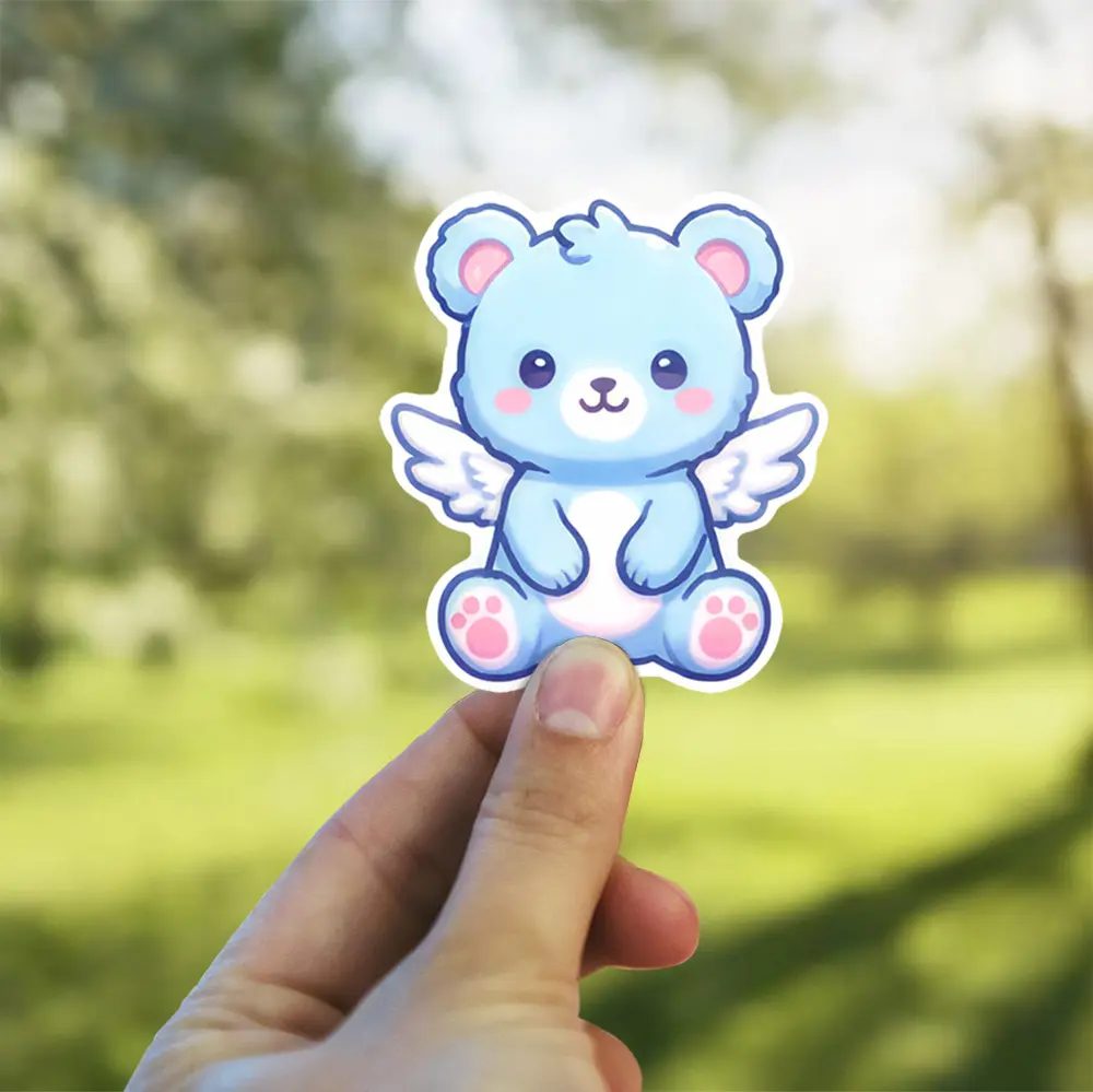 This adorable blue bear with fluffy wings is a waterproof vinyl sticker, perfect as a UV resistant decal for your water bottle or laptop.