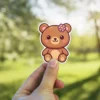 This cute kawaii bear with a pink flower is a waterproof vinyl sticker, perfect as a UV resistant decal for your water bottle or laptop.