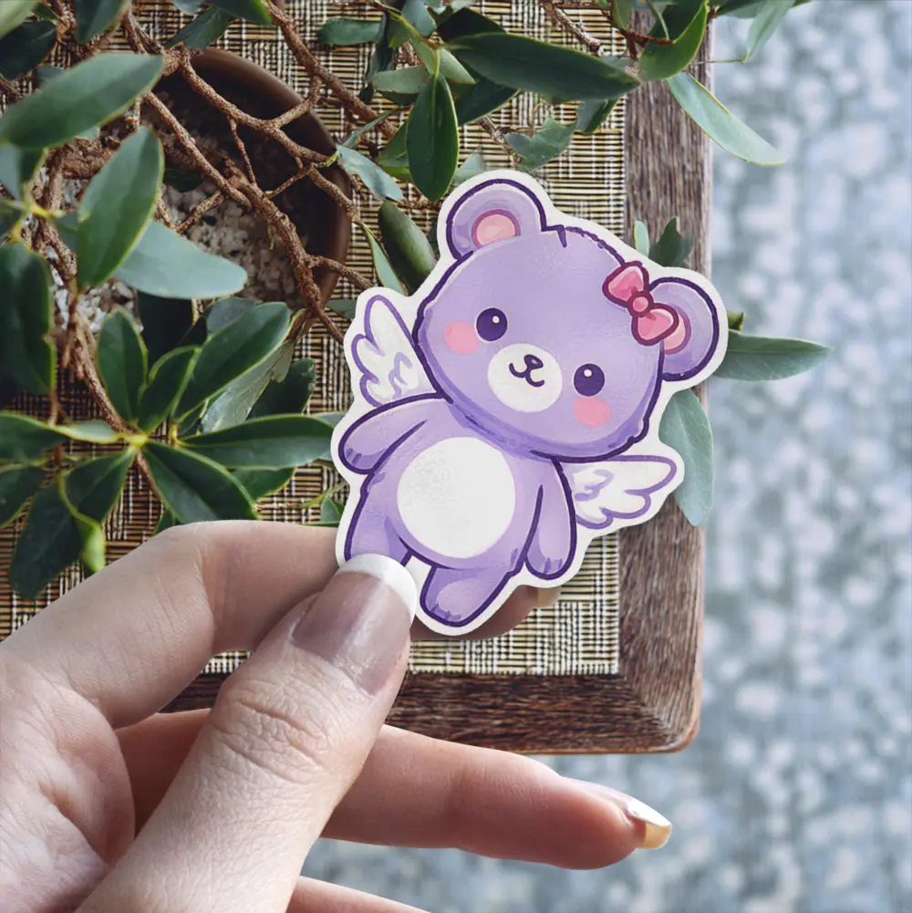 This adorable purple bear with wings and a pink bow is a waterproof vinyl sticker, perfect as a UV resistant decal for your water bottle or laptop.