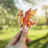 Origami dragon sticker showcases a gradient of warm oranges, a waterproof vinyl sticker perfect for laptops.