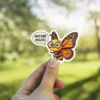A cheerful cartoon bee with monarch butterfly wings and glasses, exclaiming "Nature Rules!" as a vinyl sticker.
