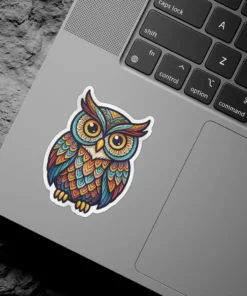 A vibrant, ornate owl sticker featuring intricate feather patterns in shades of blue, orange, red, and yellow, with large, expressive eyes.