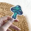 A fantasy mushroom sticker featuring a cap and stem designed with swirling galaxy patterns and bright white stars.