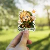 A cheerful chibi Link from Zelda waves 'good morning' under a sun, perfect for adding a touch of adventure to your belongings.