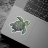 A cute, smiling sea turtle sticker with a colorful mosaic shell featuring flowers and unique patterns.