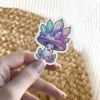 A whimsical vinyl sticker depicts a smiling mushroom character adorned with sparkling amethyst and aquamarine crystals.