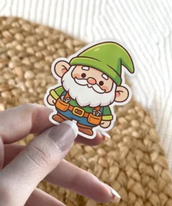 A charming vinyl sticker features a cute, smiling gnome wearing a green pointed hat and overalls, holding a hammer and screwdriver.