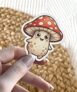 A cheerful kawaii red mushroom character sticker with a big smile and round eyes, featuring a red cap with white spots.