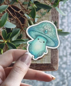 A charming teal mushroom character with a happy face and an ornate, jewel-topped cap is shown against a natural background.