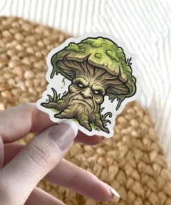 A sticker depicts a mushroom with a face like an ancient, gnarled tree, conveying a grumpy and mystical forest spirit.