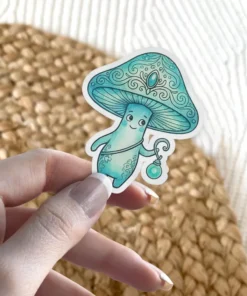 A whimsical teal mushroom character with a decorative cap and a glowing lantern is held by a person's fingers.