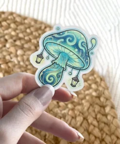 A whimsical sticker depicting a glowing blue and green mushroom adorned with miniature lanterns hanging from its cap.