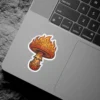 A vibrant sticker featuring a psychedelic mushroom with a cap that appears to be engulfed in flames.