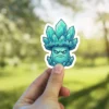A disgruntled crystal mushroom character sticker with a teal gemstone body and an angry facial expression, perfect for gaming or fantasy fans.