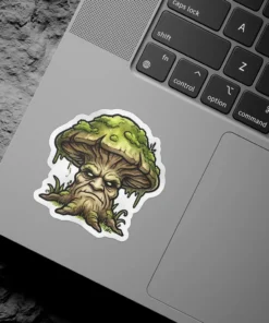 A vinyl sticker depicts a grumpy mushroom with a face, mossy cap, and wood-like stem, surrounded by grass.