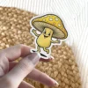 A joyful, cartoon mushroom character with a wide smile and outstretched arms is depicted in this vinyl sticker.