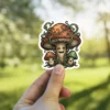 A cartoon sticker depicting a family of mushrooms with vines and expressive faces.