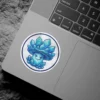 A round sticker shows a cute but mischievous mushroom character whose cap is made of sparkling blue crystals.