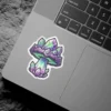 A vibrant sticker featuring a mushroom stylized with purple, green, and blue geometric crystal formations, outlined in white.