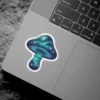 A vibrant mushroom sticker displaying a swirling galaxy of blue, green, and purple nebulae, dotted with sparkling white stars.