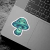 A vibrant turquoise psychedelic mushroom sticker featuring two faces with intricate patterns and a mystical third eye on its cap.