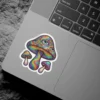A sticker features a cluster of trippy mushrooms with rainbow-colored caps covered in numerous eyes.