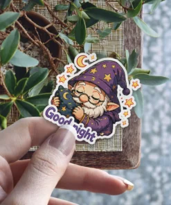 A cute wizard gnome with a purple starry hat sleeps while hugging a moon-shaped pillow with the words 'Good night' below.
