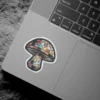 A sticker of a mushroom designed to look like stained glass with a mosaic of colorful geometric panes.