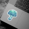 A vibrant illustration of a glowing blue and green fantasy mushroom with a textured cap and ruffled stem, outlined in white.