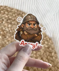 An illustration of an angry dwarf warrior with a beard, helmet, and crossed arms, with the word 'Angry!' below, vinyl sticker.