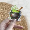 Rustic black cauldron, bubbling green potion, vibrant green steam, wooden stirring spoon, lime drips, vinyl sticker.