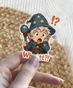 A shocked chibi wizard with a starry hat and staff exclaims 'Whattt?!' surrounded by punctuation marks, vinyl sticker.