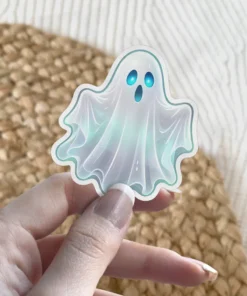 Small iridescent pastel ghost, glowing blue eyes, ethereal spooky aesthetic, die cut vinyl sticker.