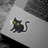 Sitting black cat, glowing lime green eyes, purple ear accents, white border, vinyl sticker