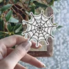 Hand-drawn spider web illustration, melting liquid effect, gothic aesthetic, black ink style, vinyl sticker