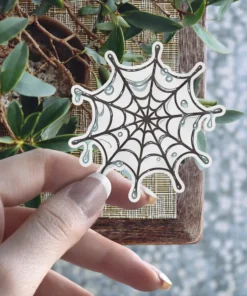 Hand-drawn spider web illustration, melting liquid effect, gothic aesthetic, black ink style, vinyl sticker