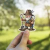 A garden gnome wearing a hat with lavender, overalls, and holding a shovel. Two keys hang from his hat.