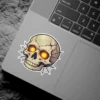 Cracked human skull, intense glowing orange eyes, intricate spider web backdrop, detailed illustration, vinyl sticker.