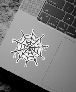 Intricate black spider web, glistening blue water droplets, gothic aesthetic design, white border, vinyl sticker.