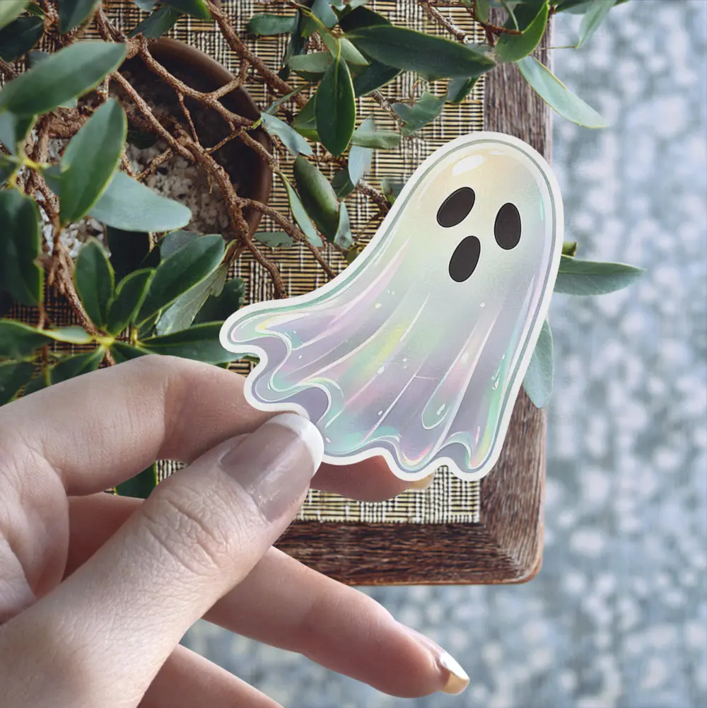 Iridescent pearlescent ghost character, black expressive eyes, mouth, die cut, holographic finish, vinyl sticker.