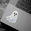 Floating iridescent ghost, spectral shimmering texture, cute spooky aesthetic, minimalist character design, holographic vinyl sticker
