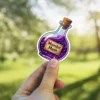 Purple glowing potion bottle, cork stopper, Monster Mash parchment label, magical elixir vinyl sticker.