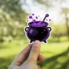 Black cauldron, purple bubbling potion, stirring stick, cartoon style, white border vinyl sticker.
