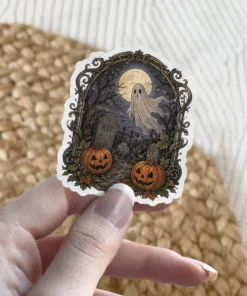 Ghost floating under full moon, spooky graveyard, jack-o'-lanterns, RIP tombstone vinyl sticker.