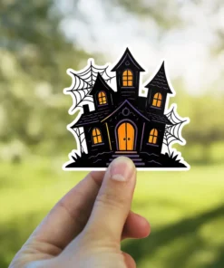 Spooky haunted house silhouette, glowing orange windows, intricate black spiderwebs, artistic gothic vinyl sticker.