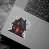Haunted house, glowing orange windows, spiderwebs, bats, graveyard silhouettes, dark artistic illustration, vinyl sticker.
