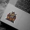 Spooky haunted house, glowing yellow windows, weathered stone texture, wooden door, dark gothic style vinyl sticker.