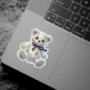 Gothic stitched teddy bear, black ribbon bow, soft pastel aesthetic, whimsical dark plushie vinyl sticker