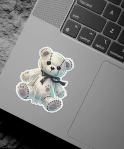 Gothic stitched teddy bear, black ribbon bow, soft pastel aesthetic, whimsical dark plushie vinyl sticker